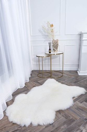 Soft and fluffy natural sheepskin rug in white colour.